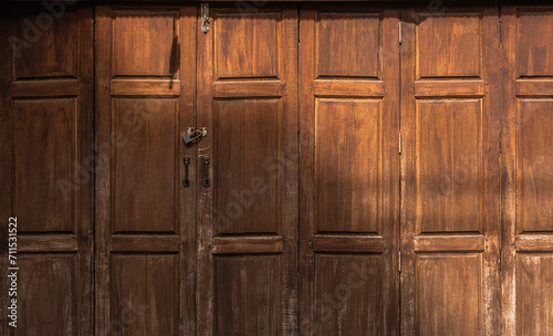 Wooden door hinged close, Brown classic vintage style background and lock key well space for text present © Nature Peaceful 
