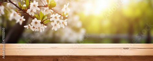 blank wooden table with spring flowers background #711532150