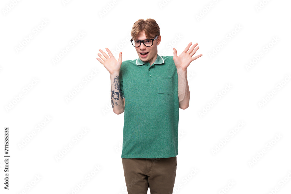 portrait of a young surprised red-haired guy in a green t-shirt with an open mouth portrait of a young surprised red-haired guy in a green t-shirt with an open mouth