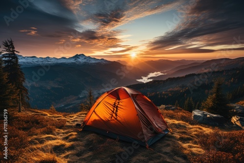 Amidst the tranquil wilderness, a lone tent stands atop a grassy hill, basking in the warm glow of the sun's rising and offering a picturesque view of the majestic mountains beyond
