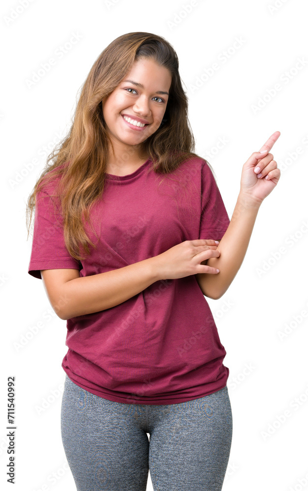 Young beautiful brunette woman over isolated background with a big smile on face, pointing with hand and finger to the side looking at the camera. Young beautiful brunette woman over isolated background with a big smile on face, pointing with hand and finger to the side looking at the camera.