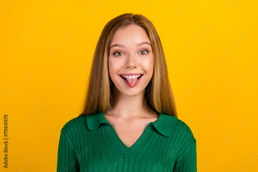 Portrait of cheerful carefree person toothy smile have good mood show tongue out isolated on yellow color background Portrait of cheerful carefree person toothy smile have good mood show tongue out isolated on yellow color background