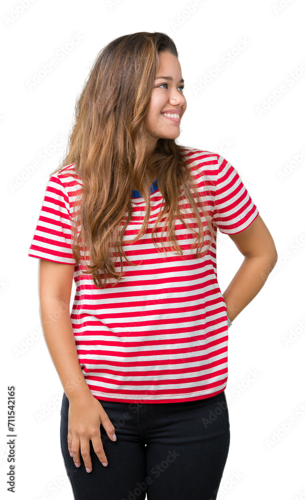 Young beautiful brunette woman wearing stripes t-shirt over isolated background looking away to side with smile on face, natural expression. Laughing confident. Young beautiful brunette woman wearing stripes t-shirt over isolated background looking away to side with smile on face, natural expression. Laughing confident.