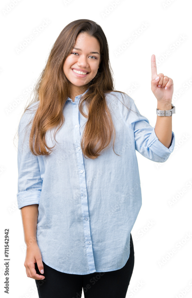 Young beautiful brunette business woman over isolated background showing and pointing up with finger number one while smiling confident and happy. Young beautiful brunette business woman over isolated background showing and pointing up with finger number one while smiling confident and happy.