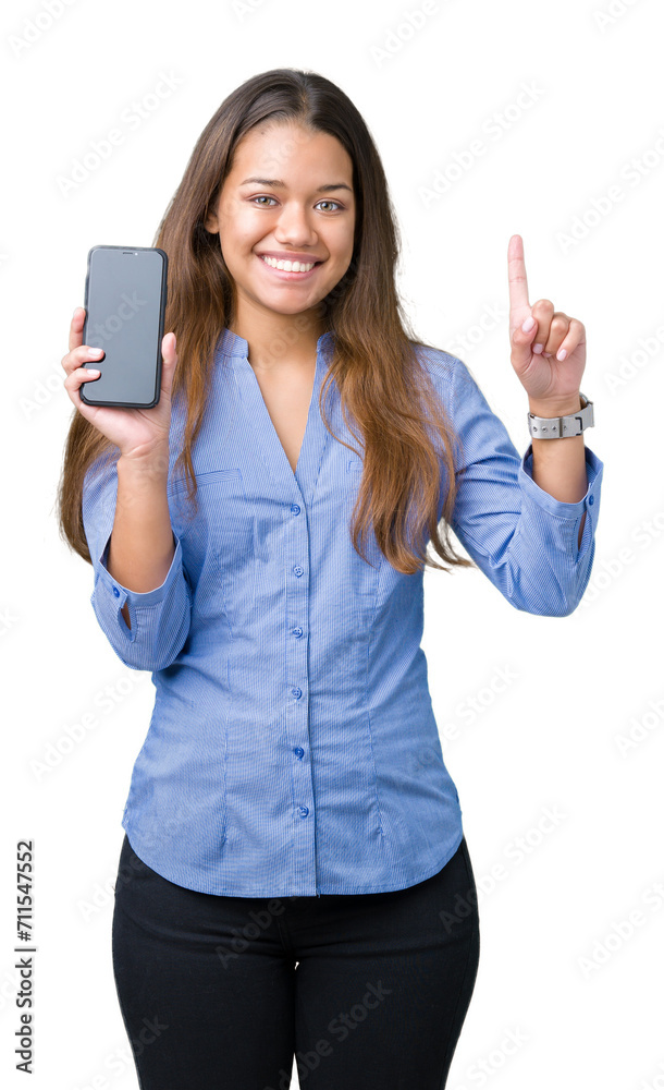 Young beautiful brunette business woman showing screen of smartphone over isolated background surprised with an idea or question pointing finger with happy face, number one Young beautiful brunette business woman showing screen of smartphone over isolated background surprised with an idea or question pointing finger with happy face, number one