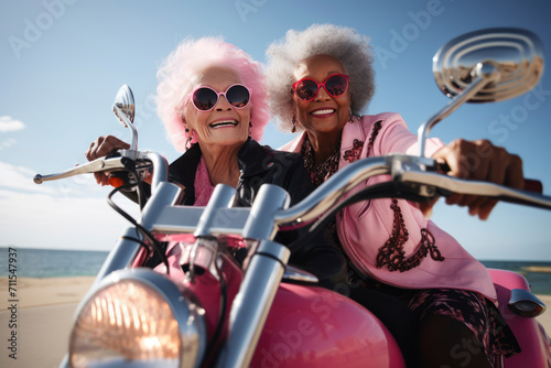 Portrait of an mature couple of women with dark skin on a motorcycle valentine's Day concept