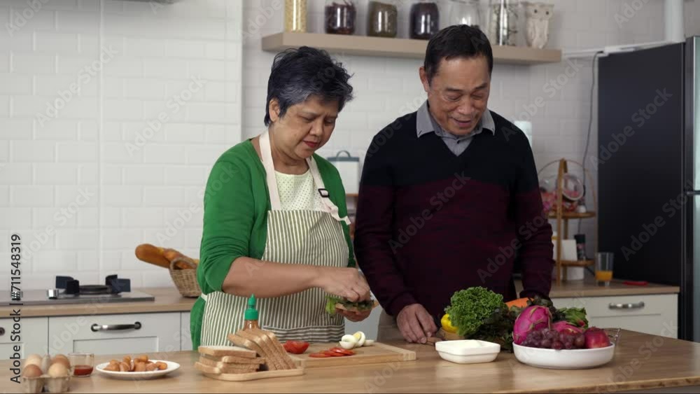 Attractive mature couple cooking foods for breakfast in kitchen with happiness Attractive mature couple cooking foods for breakfast in kitchen with happiness