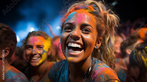 A girl smiles in the crowd at the Holi festival.