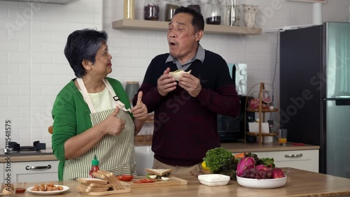 Attractive mature couple cooking foods for breakfast in kitchen with happiness