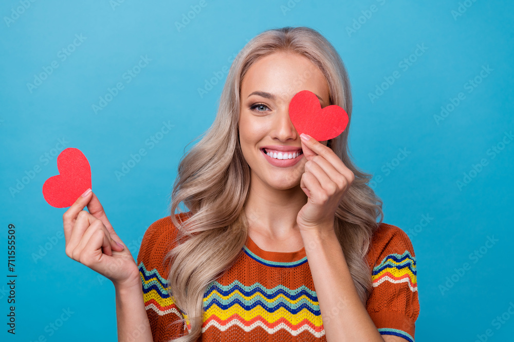 Photo of adorable shiny girl dressed print shirt little red heart close eye isolated blue color background Photo of adorable shiny girl dressed print shirt little red heart close eye isolated blue color background
