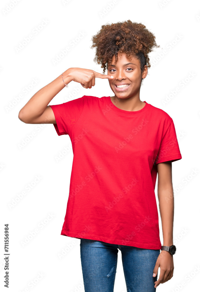 Beautiful young african american woman over isolated background Pointing with hand finger to face and nose, smiling cheerful Beautiful young african american woman over isolated background Pointing with hand finger to face and nose, smiling cheerful