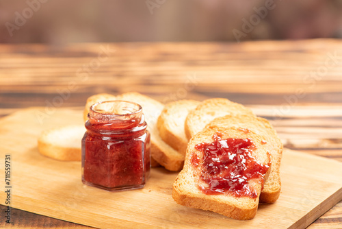 Jam and toast, jar of jam and toast on rustic wood. Selective focus.