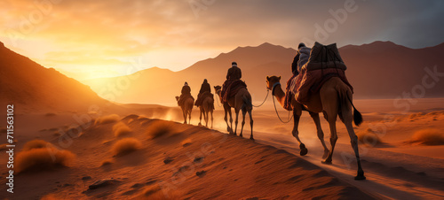 Caravan trekking through desert dunes at golden sunset