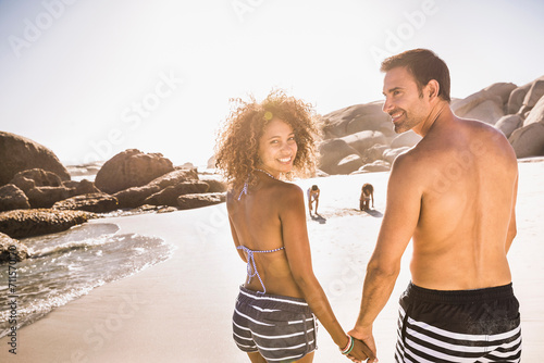 Mixed race family having fun playing on the beach. Cape Town, South Africa