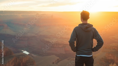 Man looking into a vast canyon with his back turned generative ai