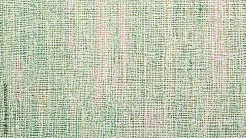 Close-up of weaved, tweed style fabric in pastel colors for spring backdrops. Warp, weft threads in pink, green, pale brown, light yellow color. Celebrate spring, nice weather with unique fabrics.