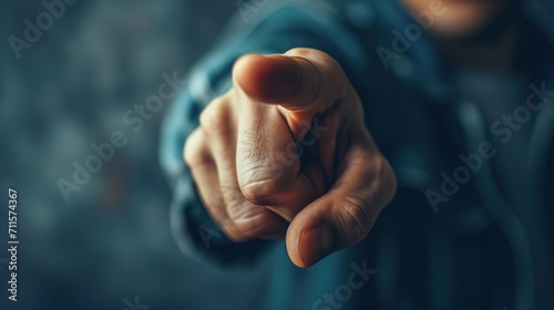 Close-up of a Caucasian unrecognizable man hand pointing with a finger at camera, gesture photo