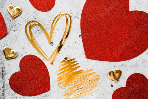 Festive background with red and gold hearts on a gray concrete background. valentine\'s day. Love.