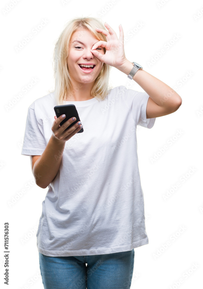 Young beautiful blonde woman using smartphone over isolated background with happy face smiling doing ok sign with hand on eye looking through fingers Young beautiful blonde woman using smartphone over isolated background with happy face smiling doing ok sign with hand on eye looking through fingers