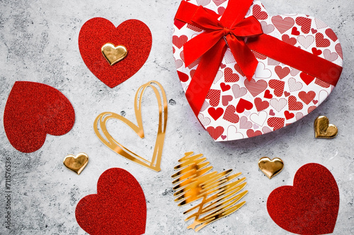 Festive background with red and gold hearts on a gray concrete background. valentine\'s day. Love.