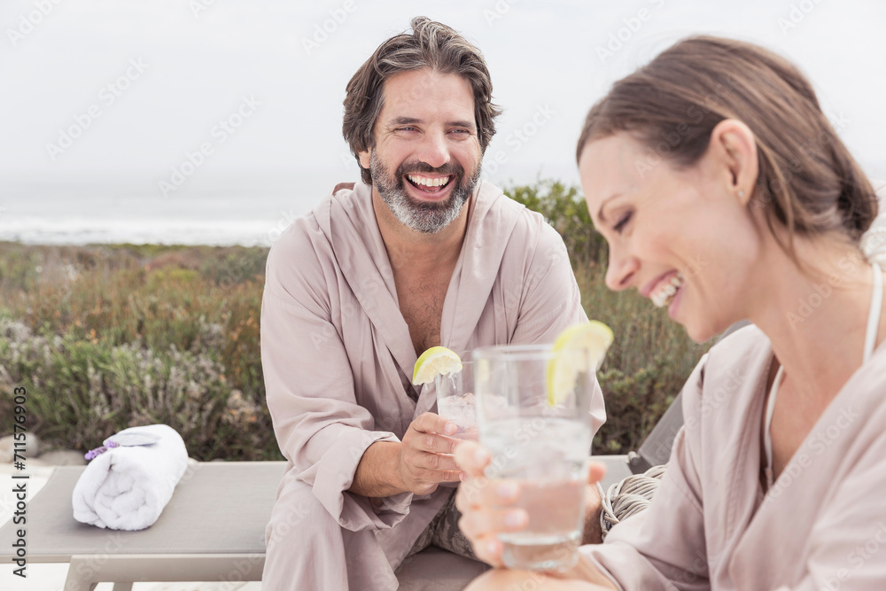 Middle aged couple arm in arm enjoying a spa day. Grotto Bay, South Africa Middle aged couple arm in arm enjoying a spa day. Grotto Bay, South Africa