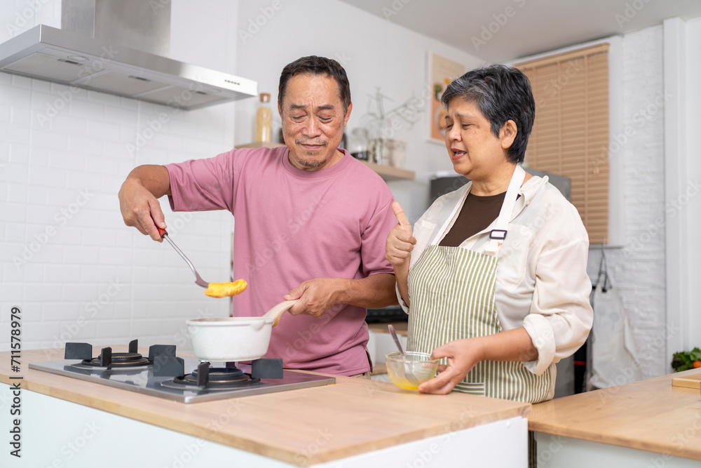 Mature asian Couples enjoy to cooking meal together in kitchen. Mature asian Couples enjoy to cooking meal together in kitchen.