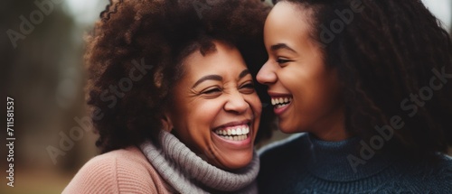 Mother’s day. African American mother and daughter smiling happily photo