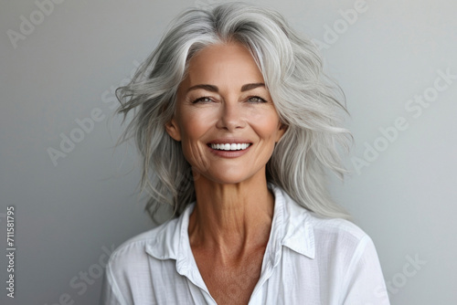 50s middle aged old woman looking at camera isolated on white background advertising dry skin care treatment anti age skincare beauty, plastic surgery, cosmetology procedures. photo