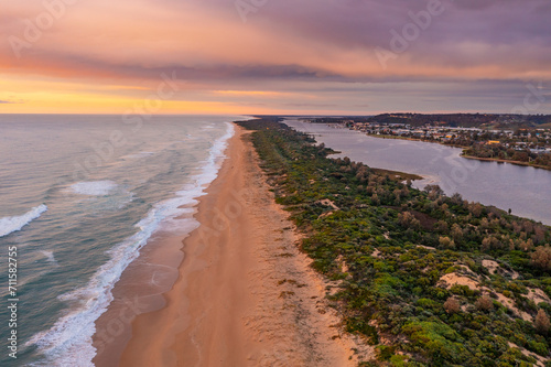 Wallpaper Mural Aerial view down a long sandy beach under a colourful sunset sky Torontodigital.ca