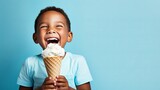 Cheerful kid enjoying ice cream in waffle cone on blue background with space for text