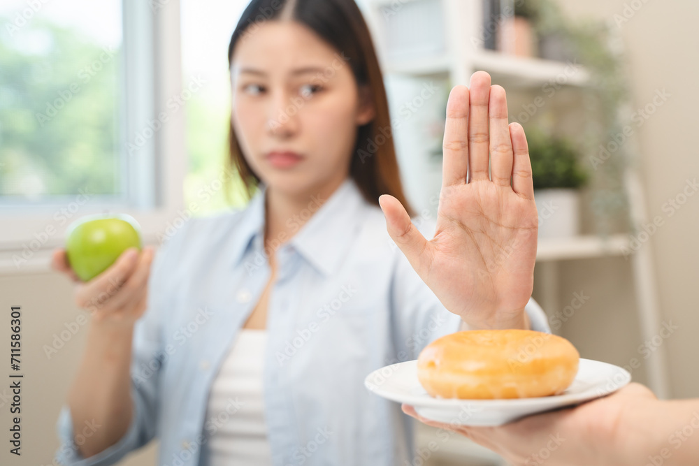 Diet food loss weight concept, Hand of woman pushing sweet away and avoid to eat fried chicken to control cholesterol and sugar. Diet food loss weight concept, Hand of woman pushing sweet away and avoid to eat fried chicken to control cholesterol and sugar.