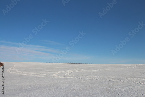A large flat plain with blue sky and clouds