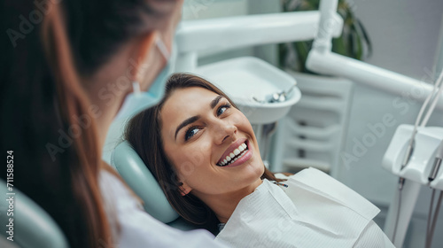 Cheerful woman reclines in a dentist's chair, displaying bright smile in modern and clean dental clinic, conveying positive healthcare experience.