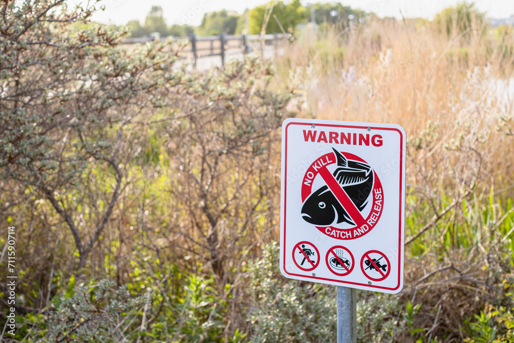 Sign to regulate fishing rules - Warning. No kill. Catch and release. Sign to regulate fishing rules - Warning. No kill. Catch and release.
