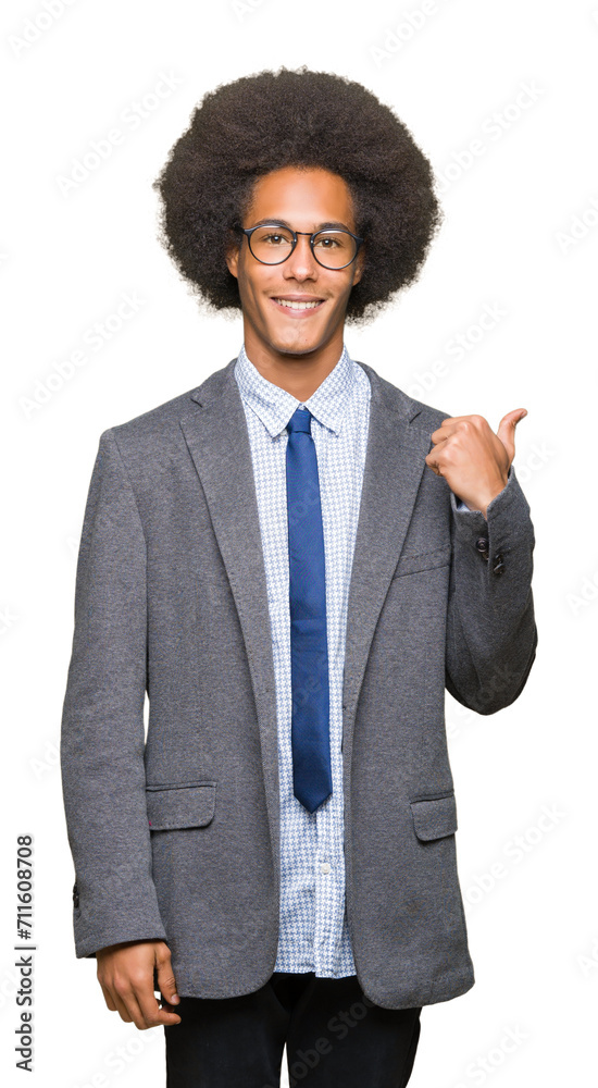 Young african american business man with afro hair wearing glasses smiling with happy face looking and pointing to the side with thumb up. Young african american business man with afro hair wearing glasses smiling with happy face looking and pointing to the side with thumb up.