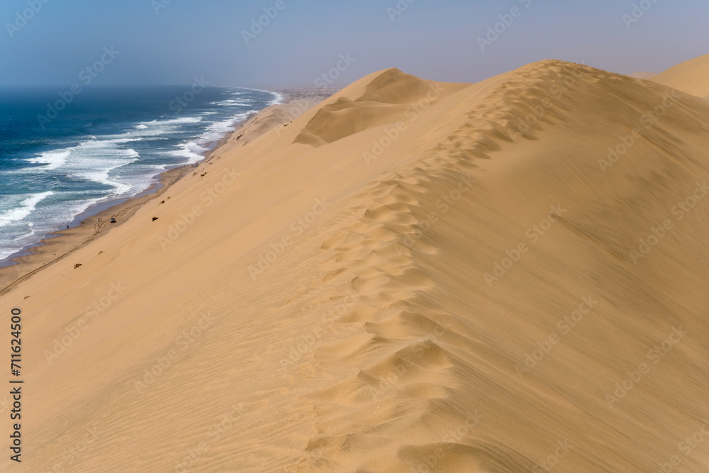 footprints on dune edge at Atlantic shore near Sandwich Harbour, Namibia