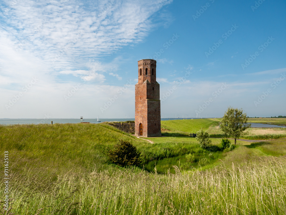 Former church tower Plompetoren on dike at Oosterschelde, Easter Scheldt, estuary, Zeeland, Netherlands