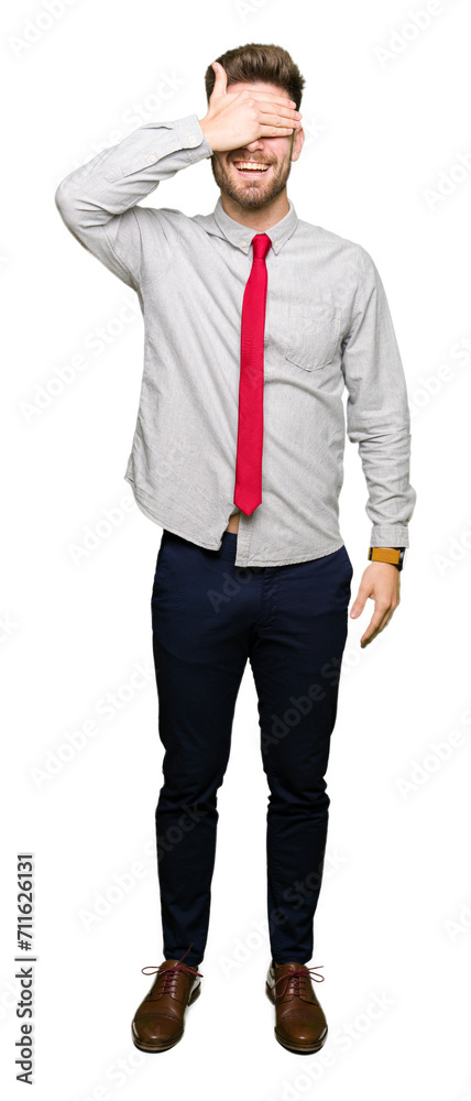 Young handsome business man smiling and laughing with hand on face covering eyes for surprise. Blind concept. Young handsome business man smiling and laughing with hand on face covering eyes for surprise. Blind concept.