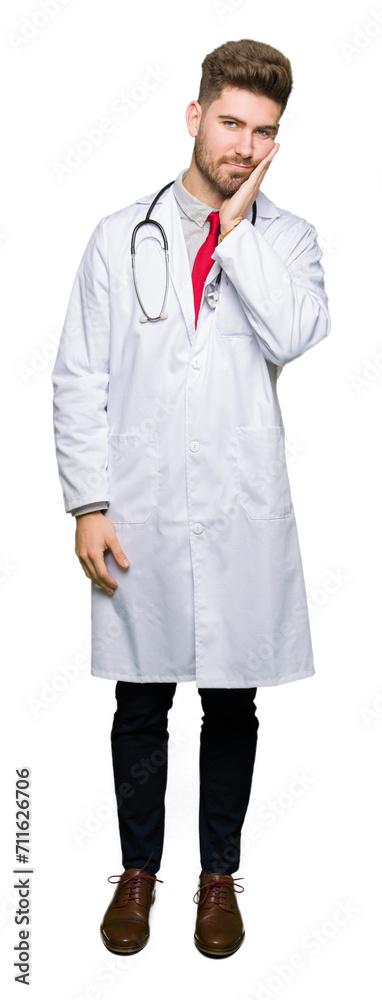 Young handsome doctor man wearing medical coat thinking looking tired and bored with depression problems with crossed arms. Young handsome doctor man wearing medical coat thinking looking tired and bored with depression problems with crossed arms.