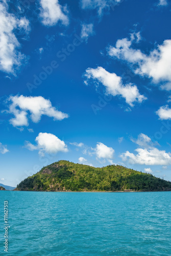 Tropical island with crystal clear water and beautiful blue sky. Travel and holiday concept © jovannig