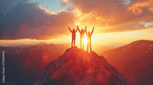 Together overcoming obstacles as a group of three people raising hands up on the top of a mountain. Celebrate victory and success over sunset background. Goal achievement symbol