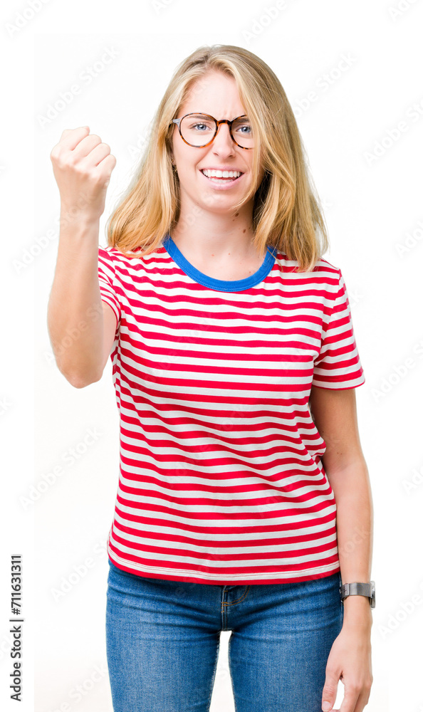 Beautiful young woman wearing glasses over isolated background angry and mad raising fist frustrated and furious while shouting with anger. Rage and aggressive concept. Beautiful young woman wearing glasses over isolated background angry and mad raising fist frustrated and furious while shouting with anger. Rage and aggressive concept.
