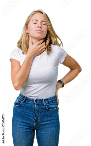 Beautiful young woman wearing casual white t-shirt over isolated background Touching painful neck, sore throat for flu, clod and infection
