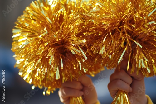 Sparkling Gold Pompoms To Amplify Cheerleading Spirit photo