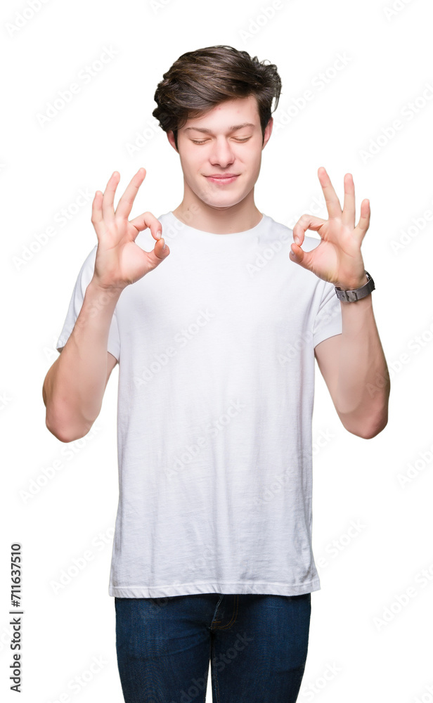 Young handsome man wearing casual white t-shirt over isolated background relax and smiling with eyes closed doing meditation gesture with fingers. Yoga concept. Young handsome man wearing casual white t-shirt over isolated background relax and smiling with eyes closed doing meditation gesture with fingers. Yoga concept.