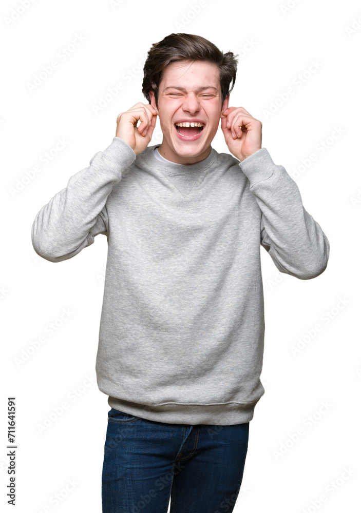 Young handsome sporty man wearing sweatshirt over isolated background covering ears with fingers with annoyed expression for the noise of loud music. Deaf concept. Young handsome sporty man wearing sweatshirt over isolated background covering ears with fingers with annoyed expression for the noise of loud music. Deaf concept.