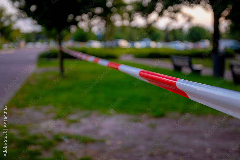 Soft selective focus of brightly barricade tape, Closed area with red and white striped danger barrier tape, Use to temporarily section off hazardous or prevent people from coming together.