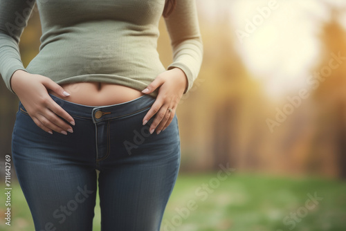 Woman with stomachache holds hands on belly. Female with intestinal inflammation touching abdomen. Lady with bloating sign of irritable bowel syndrome, farting, lactose intolerance and celiac disease. photo