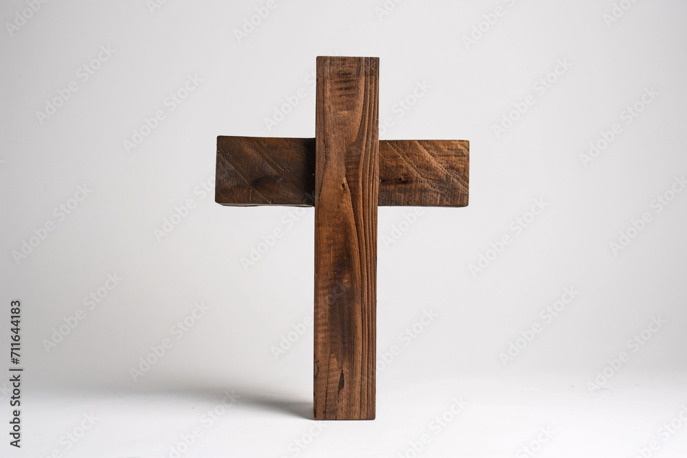 Rustic wooden cross against a plain white background