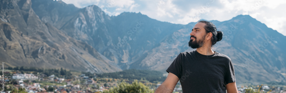 A man on the background of an autumn mountain landscape. A man on the background of an autumn mountain landscape.